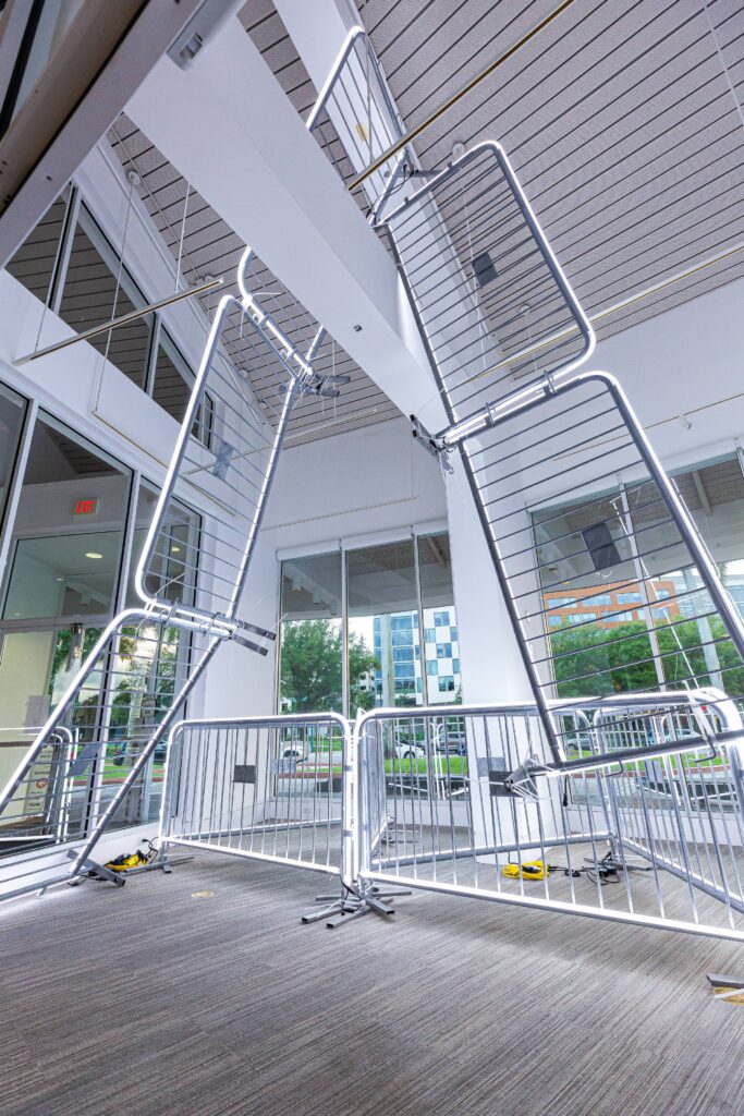 Antonia Wright and Ruben Millares,What Goes Up, Must Come Down, 2024 Steel barricades, LED lights, zip ties Dimensions variable Installation from the Lowe Art Museum